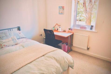 A bright and inviting double bedroom with a coz...