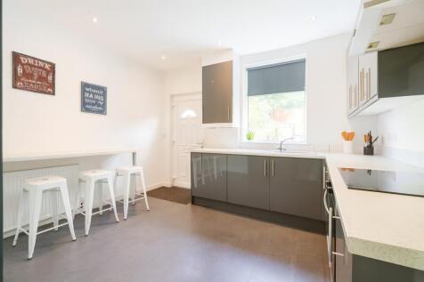 Bright and modern kitchen with sleek grey cabin...