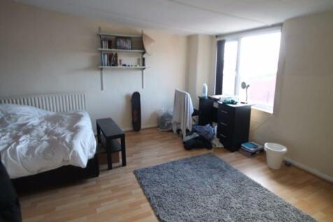 A bright and inviting bedroom with ample space ...