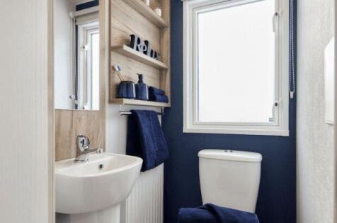 Modern Bathroom With Navy Feature Wall, Sink And T