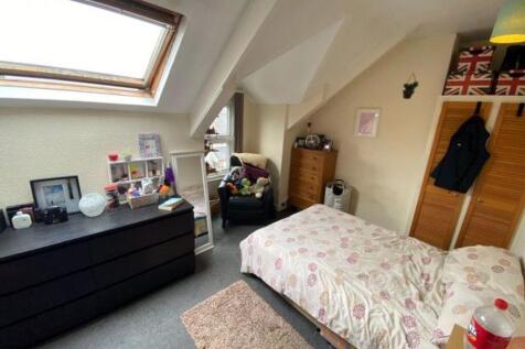 Bright and cozy master bedroom featuring a doub...