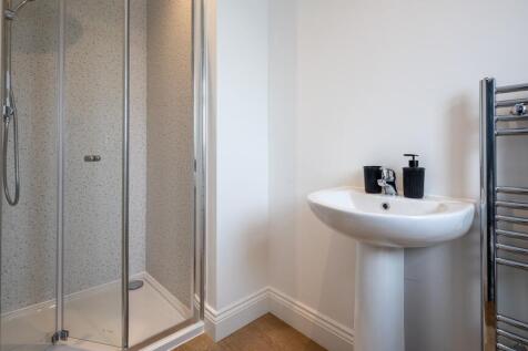 Modern bathroom with a sleek glass shower enclo...