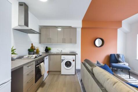 A stylish and modern kitchenette featuring ampl...