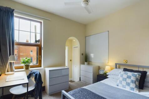 A bright and inviting double bedroom featuring ...