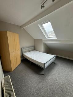 Bright attic bedroom with a skylight, simple me...