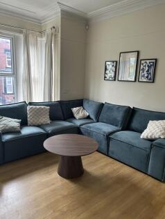 Bright living room with large corner sofa...