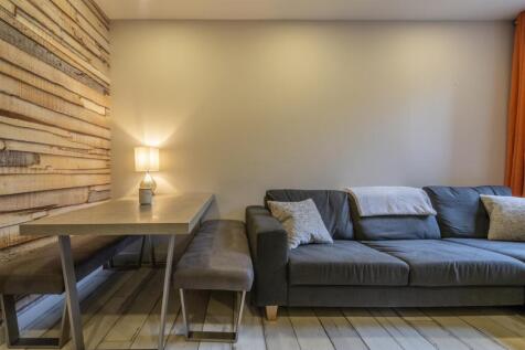 Cozy living space with comfortable sofa and din...