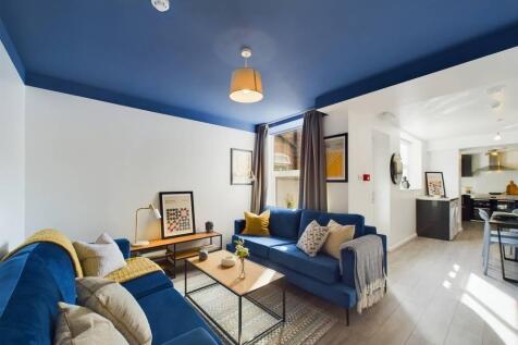 Bright, contemporary living room with coordinat...