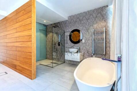 Modern bathroom with a freestanding bathtub, glass