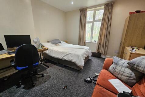 A bright and welcoming bedroom with a comfortab...