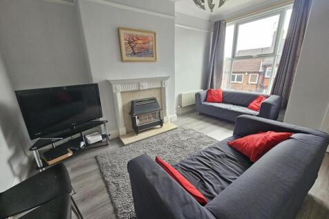 A bright, contemporary living room featuring a ...