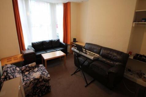 A well-lit living room featuring comfortable se...