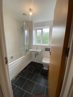 Bright and modern bathroom featuring a large ba...