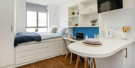 Modern bedroom with integrated study and storag...