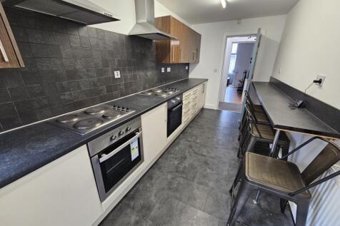 Bright and modern kitchen with sleek black coun...