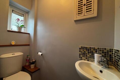 Modern cloakroom with stylish mosaic tiling....