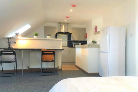 Bright and clean master bedroom featuring a stu...