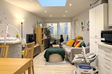 Bright, modern open-plan living area with a com...