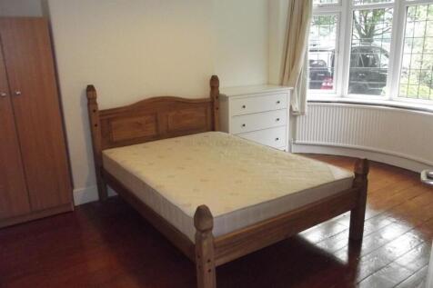 Bright double bedroom with a wooden bed frame, ...