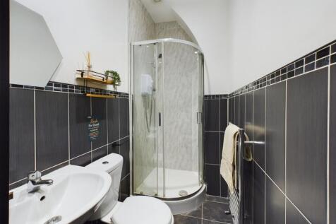 A stylish and modern bathroom featuring a sleek...