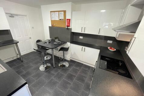 Modern fitted kitchen with glossy white cabinet...