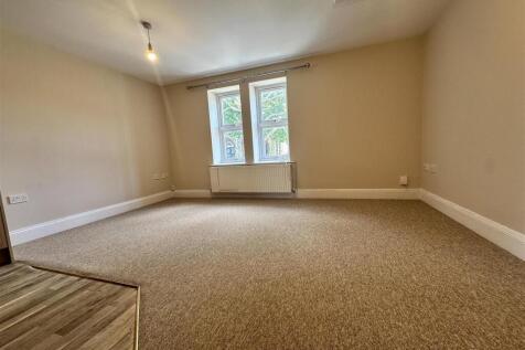 Bright, spacious living area with fresh carpet....