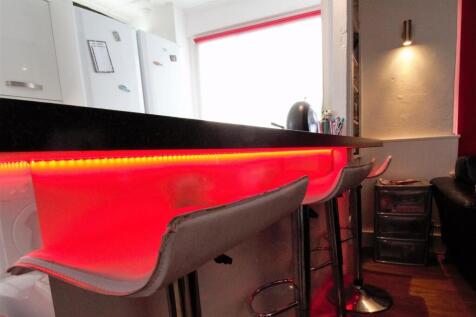 Modern kitchen bar with vibrant LED lighting...