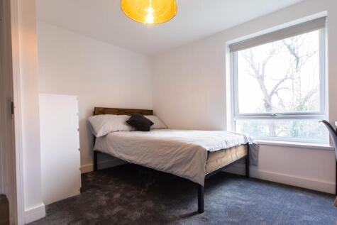 Bright, modern bedroom with a comfortable doubl...