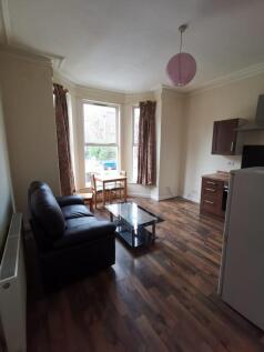 Bright open-plan living with large bay windows...