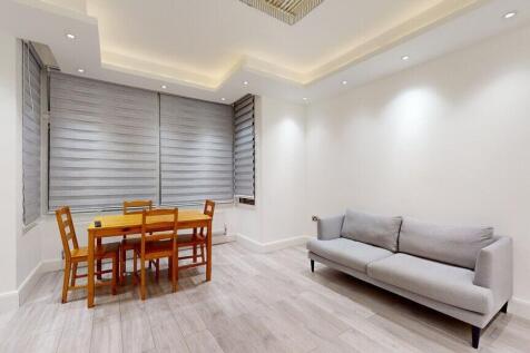 Bright modern living area with dining table...