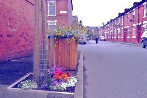 Charming street with colorful flower planters...