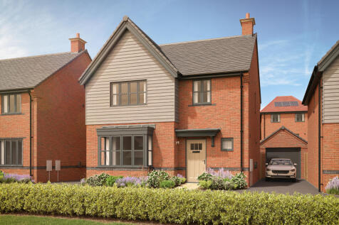 A modern brick house with a grey-paneled upper story and a manicured lawn in the foreground is set a