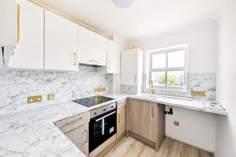 Bright modern kitchen with marble worktops...