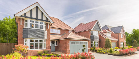 A row of Heritage homes with green surroundings on a warm summers day