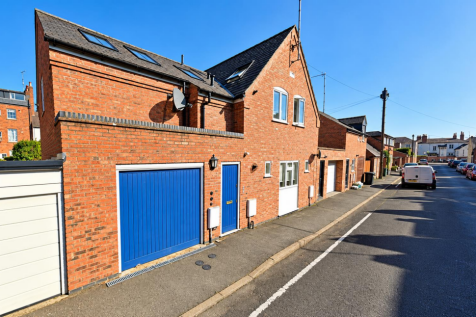 Sunny Brick Townhouses and Blue Garage Doors.png