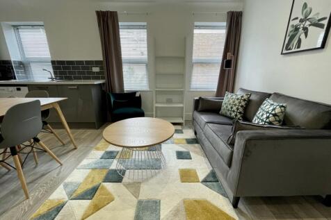 A bright and inviting living room featuring a c...