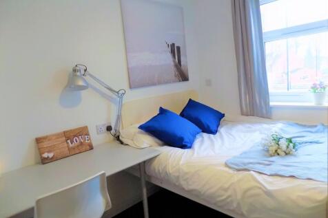 A bright and inviting single bedroom featuring ...