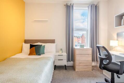 Bright bedroom with stylish yellow feature wall...