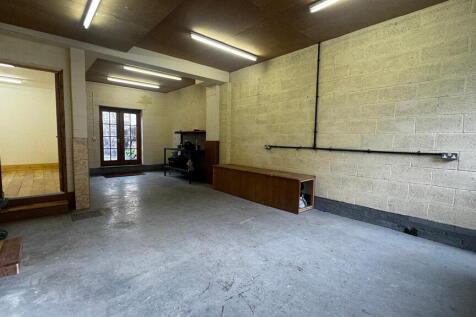Large, clean garage/storage space with concrete...