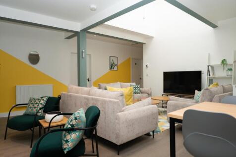 A stylish and contemporary living room featurin...