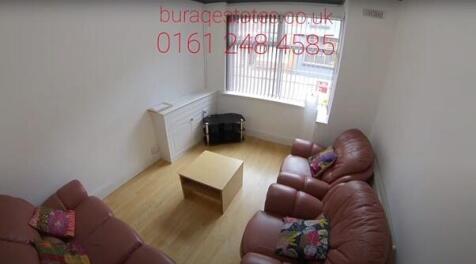 Bright, simply furnished living room with lamin...