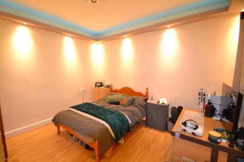Well-lit double bedroom with warm recessed ligh...