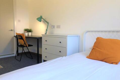 A neat and functional single bedroom featuring ...