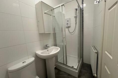 Modern tiled bathroom with sleek glass shower....
