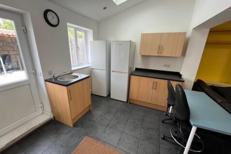 Bright, modern kitchen with tiled flooring, two...