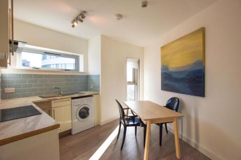 Bright, modern kitchen with a dining area...