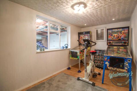 Home gym or play room with loft room storage above
