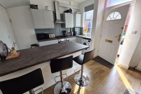Bright and modern kitchen area featuring a brea...