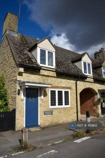 Front Of House With Archway To Parking Behind