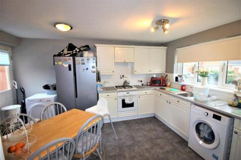 Bright kitchen with dining table and appliances...